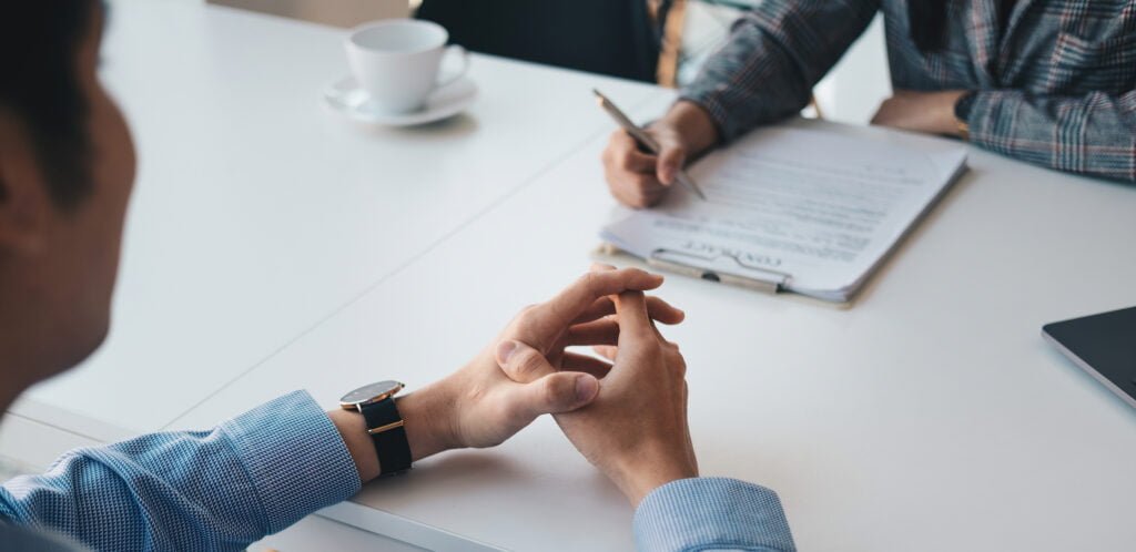 Employer or recruiter reading a resume during about colloquy his profile of candidate, employer conducting a job interview, manager resource employment and recruitment concept.